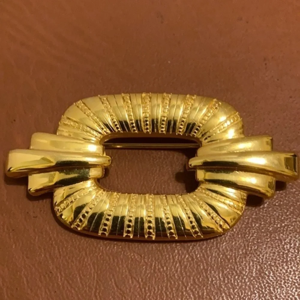 TAT signed gold tone Art Deco style pin